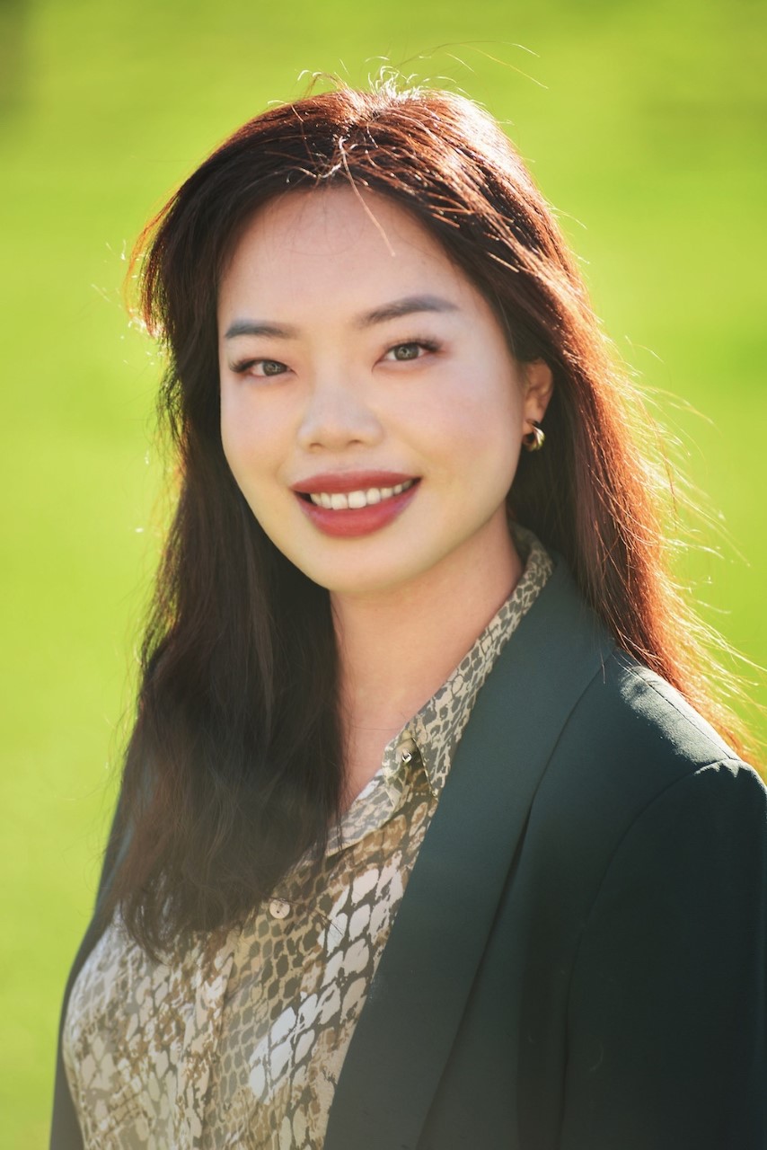 Jessica Lee outdoors in a dark green blazer
