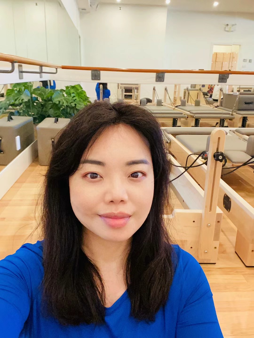 Jessica at a Pilates studio with reformers